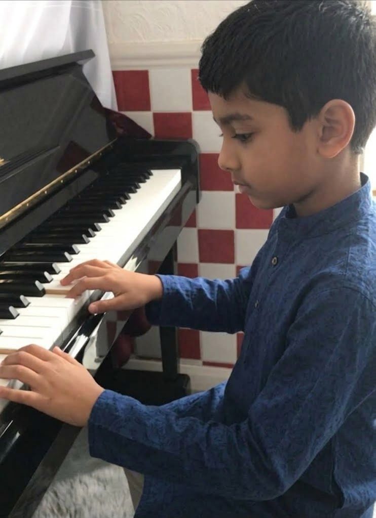 A pupil playing the piano