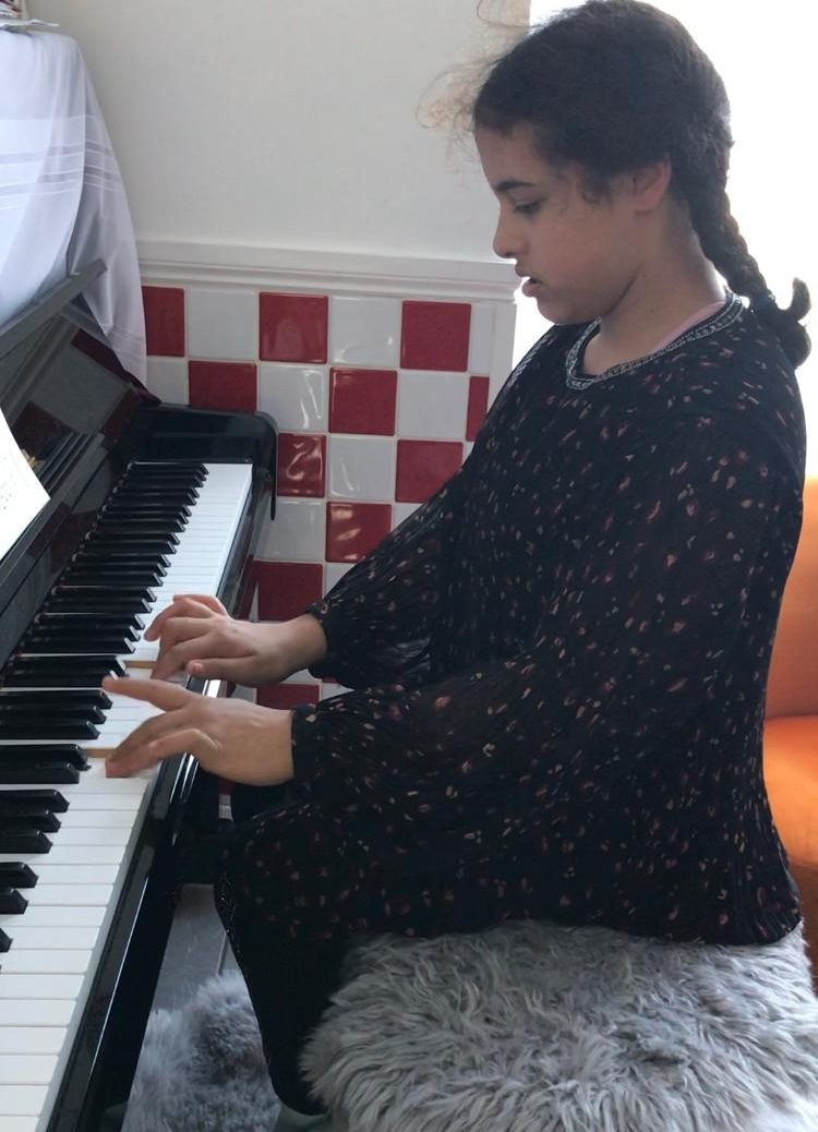 A pupil playing the piano