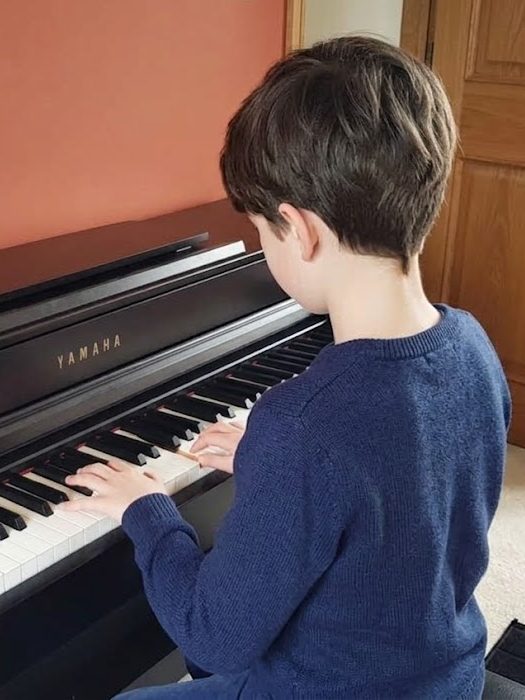 A pupil playing the piano